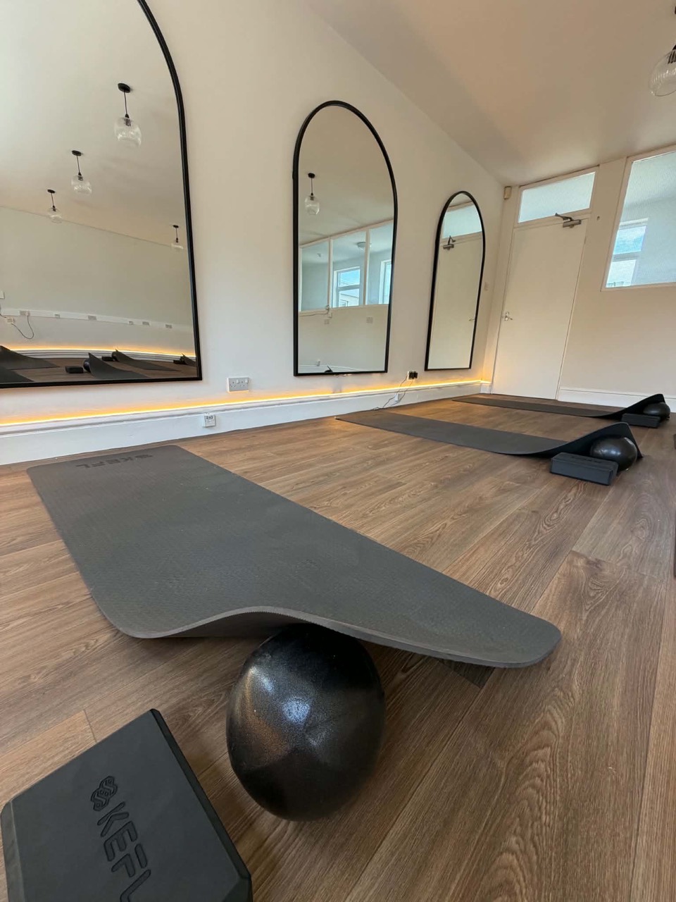 A Pilates mat, ball and blocks in the studio